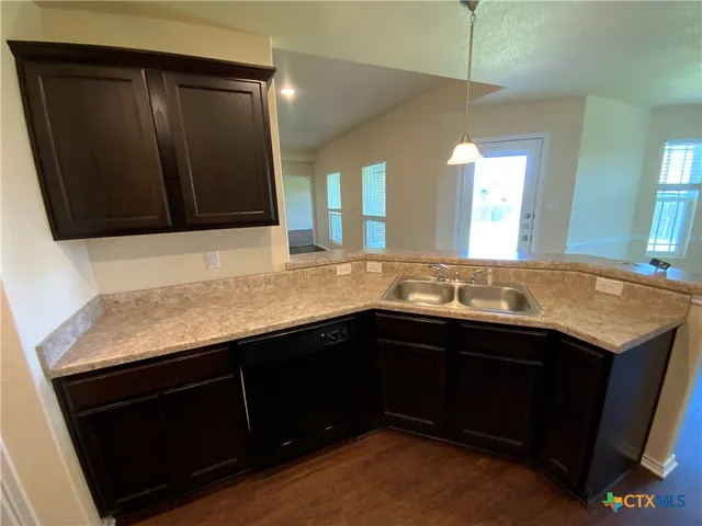 a kitchen with a sink and a stove