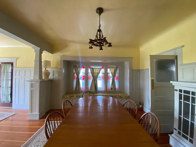 a view of a dining room with furniture and chandelier