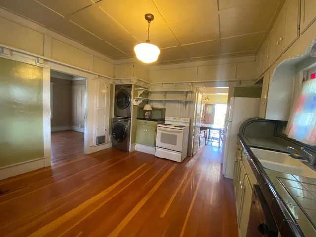 a kitchen with stainless steel appliances granite countertop a sink and wooden cabinets