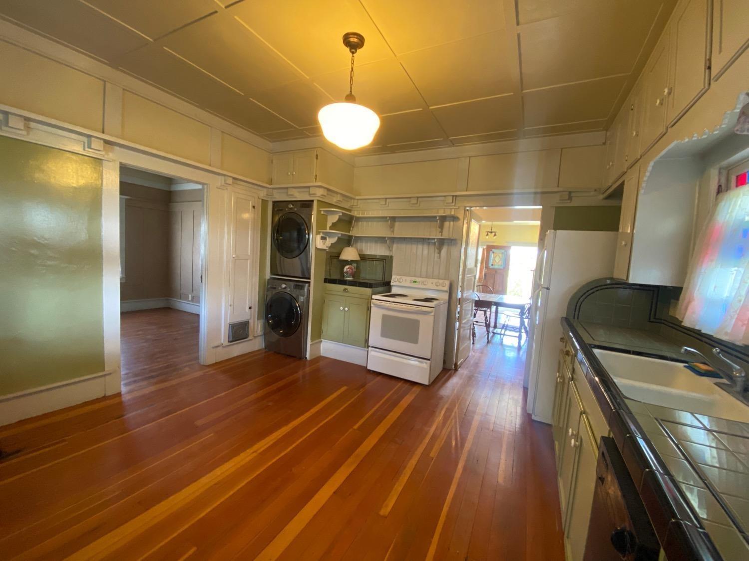 700 Wellsford Road Modesto, CA 95357 - Photo 17 of 47 a kitchen with stainless steel appliances wooden floor and a refrigerator