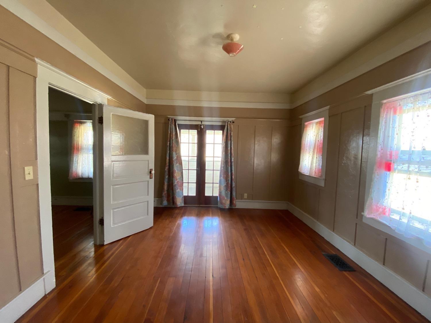 700 Wellsford Road Modesto, CA 95357 - Photo 19 of 47 an empty room with wooden floor and windows
