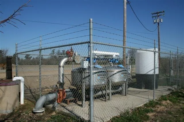 a view of a dining room and livingroom with furniture wooden floor a chandelier