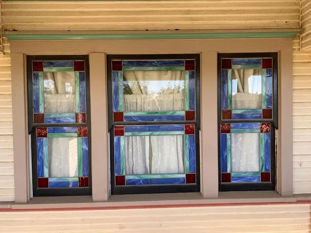 a view of a hallway with wooden floor and windows