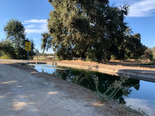 a kitchen with granite countertop a refrigerator and a stove top oven
