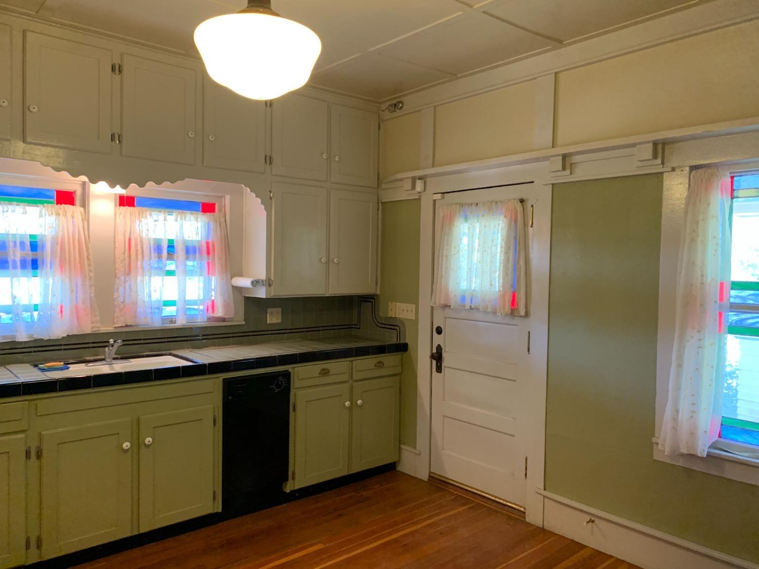 700 Wellsford Road Modesto, CA 95357 - Photo 33 of 47 a kitchen with a sink cabinets and wooden floor