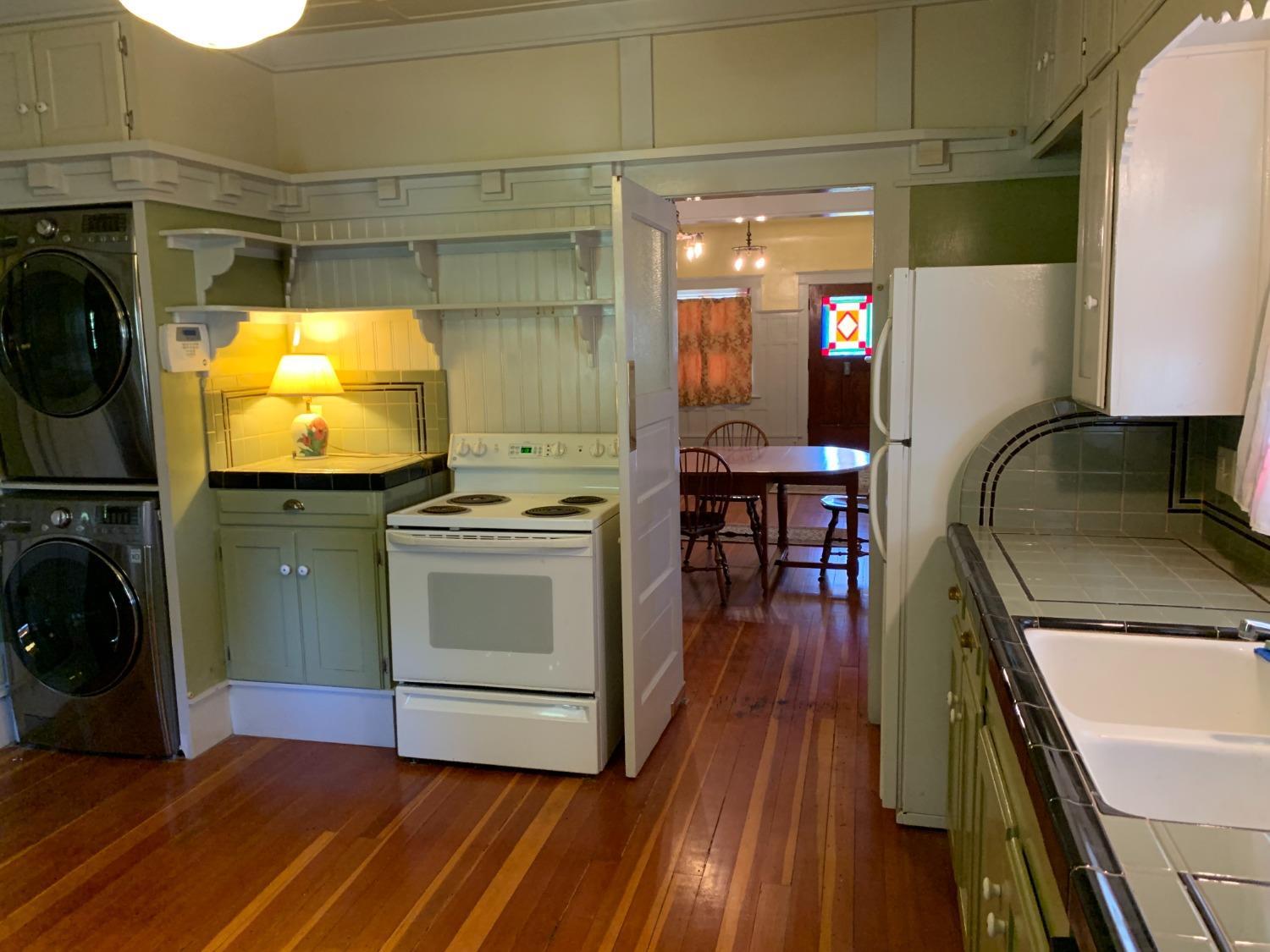 700 Wellsford Road Modesto, CA 95357 - Photo 35 of 47 a kitchen with a sink and wooden floor