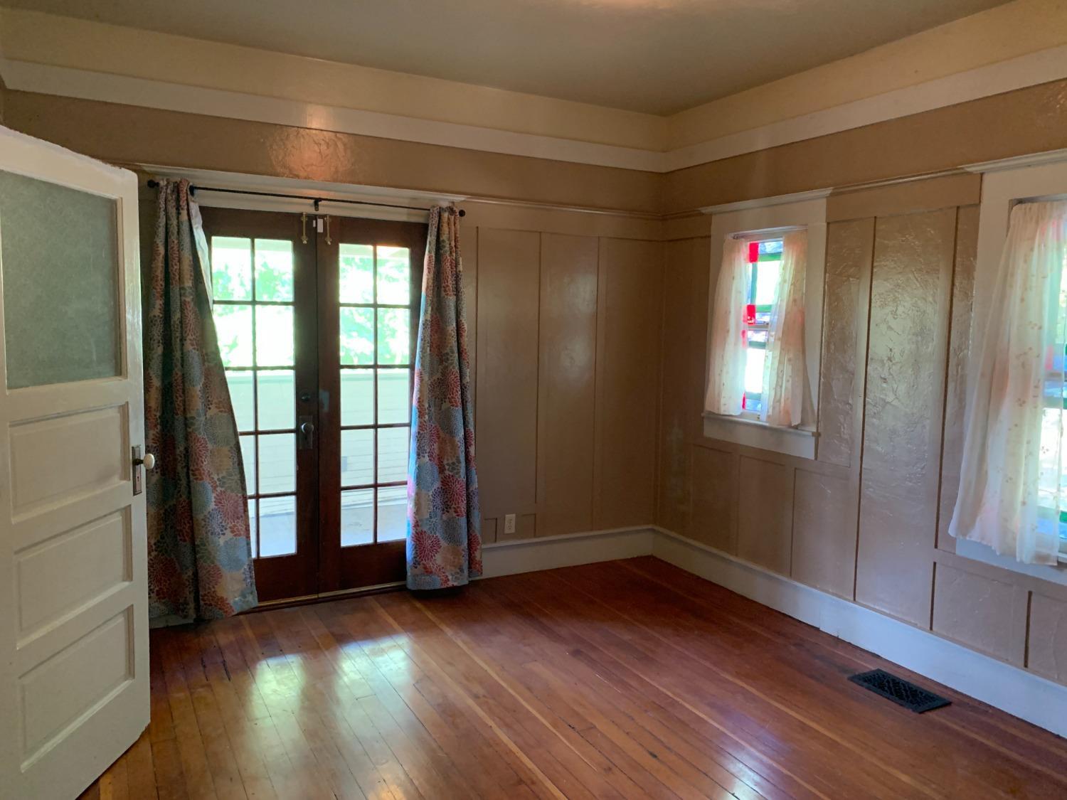 700 Wellsford Road Modesto, CA 95357 - Photo 37 of 47 wooden floor and windows in an empty room