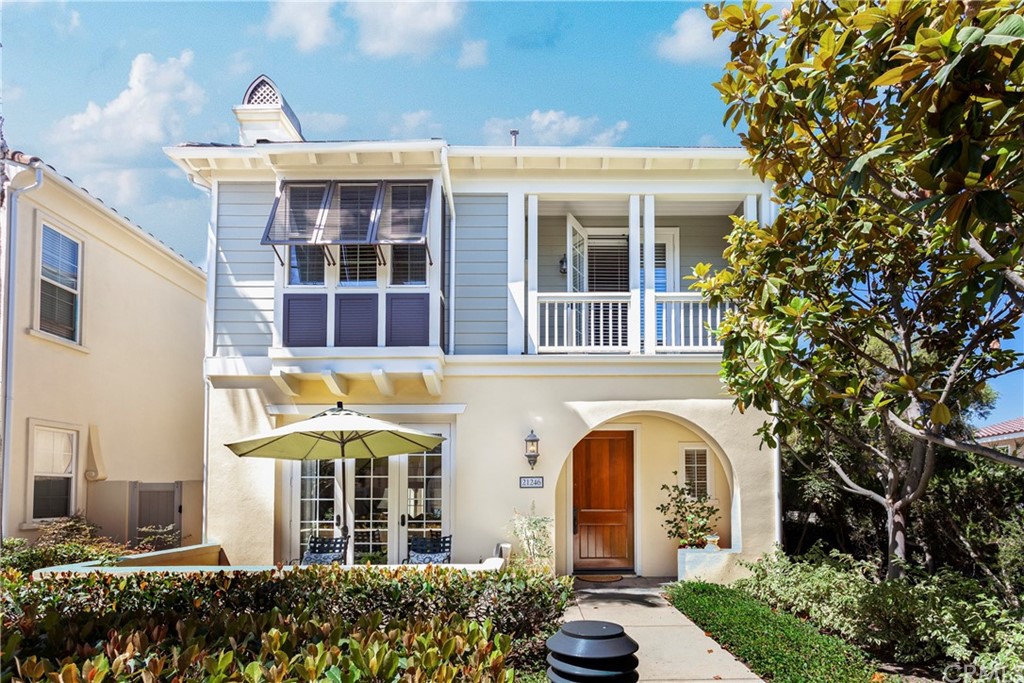21246 Baeza Circle Huntington Beach, CA 92648 - Photo 1 of 49 a front view of a house with a garden