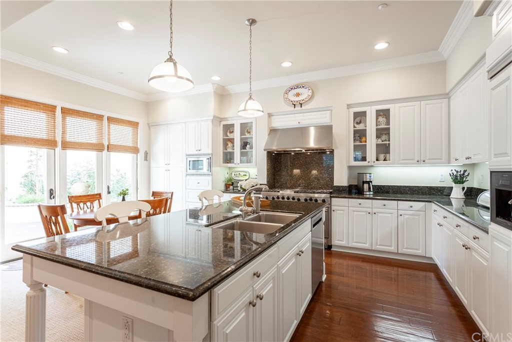 21246 Baeza Circle Huntington Beach, CA 92648 - Photo 13 of 49 a kitchen with stainless steel appliances granite countertop a sink a stove and a counter space