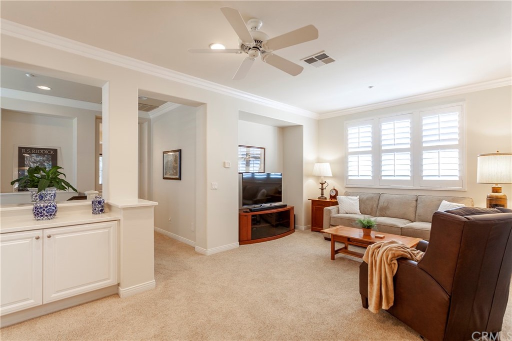 21246 Baeza Circle Huntington Beach, CA 92648 - Photo 18 of 49 a living room with furniture a flat screen tv and a window