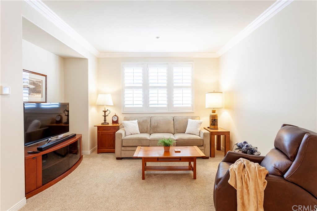21246 Baeza Circle Huntington Beach, CA 92648 - Photo 19 of 49 a living room with furniture a flat screen tv and a window