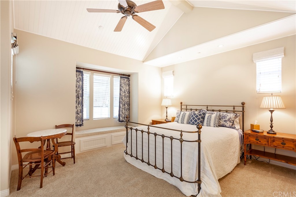 21246 Baeza Circle Huntington Beach, CA 92648 - Photo 21 of 49 a bedroom with a bed and a chandelier