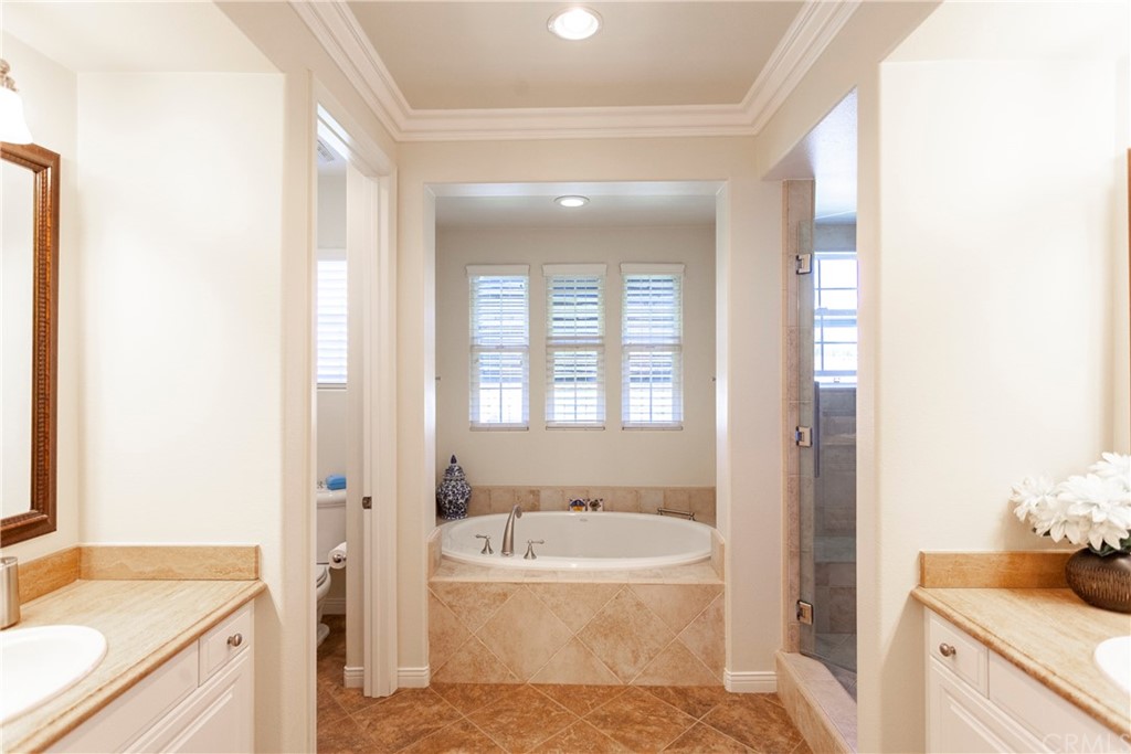 21246 Baeza Circle Huntington Beach, CA 92648 - Photo 25 of 49 a bathroom with a tub sink and a mirror
