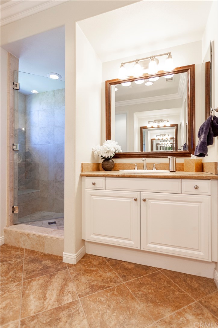 21246 Baeza Circle Huntington Beach, CA 92648 - Photo 26 of 49 a bathroom with a sink a mirror and a shower