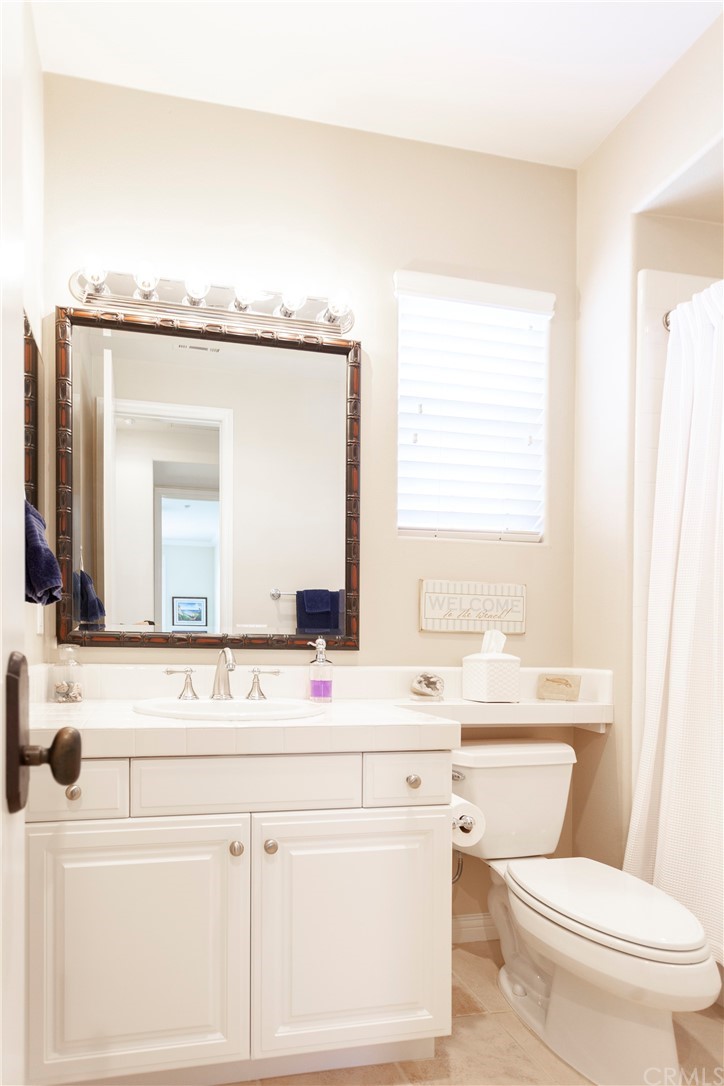 21246 Baeza Circle Huntington Beach, CA 92648 - Photo 33 of 49 a bathroom with a granite countertop toilet sink and mirror