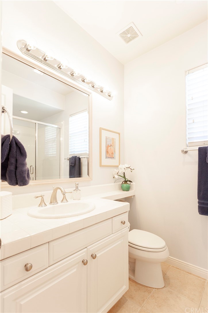21246 Baeza Circle Huntington Beach, CA 92648 - Photo 35 of 49 a bathroom with a sink a toilet and a mirror