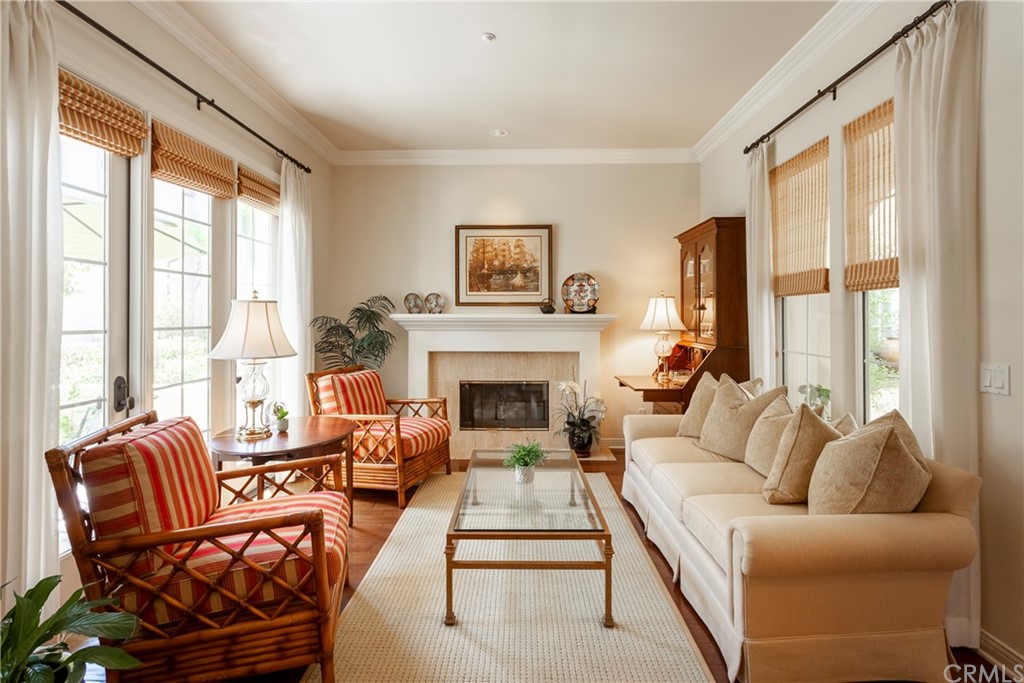 21246 Baeza Circle Huntington Beach, CA 92648 - Photo 6 of 49 a living room with furniture a large window and a fireplace