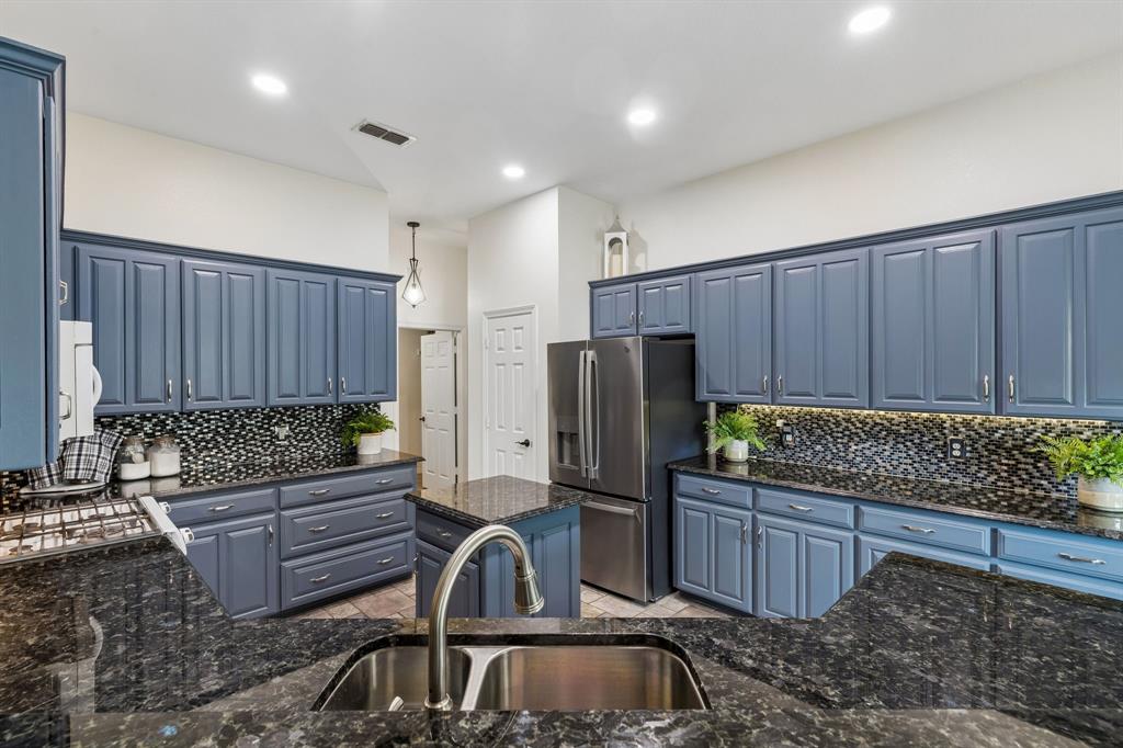 1901 Saw Tooth Court Haslet, TX 76052 - Photo 11 of 38 a kitchen with sink a refrigerator and cabinets