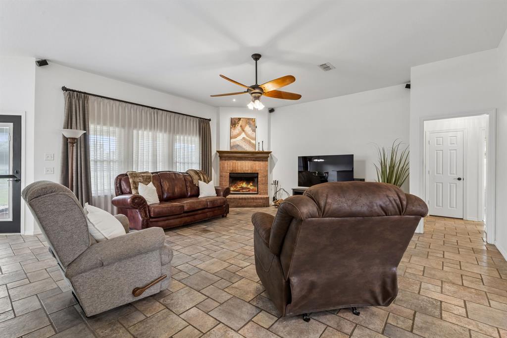1901 Saw Tooth Court Haslet, TX 76052 - Photo 13 of 38 a living room with furniture a fireplace and a large window