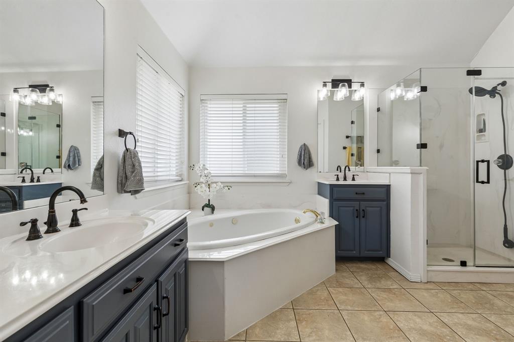 1901 Saw Tooth Court Haslet, TX 76052 - Photo 20 of 38 a bathroom with a tub sink and mirror