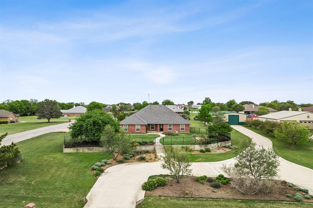 1901 Saw Tooth Court Haslet, TX 76052 - Photo 2 of 38 a front view of a house with garden