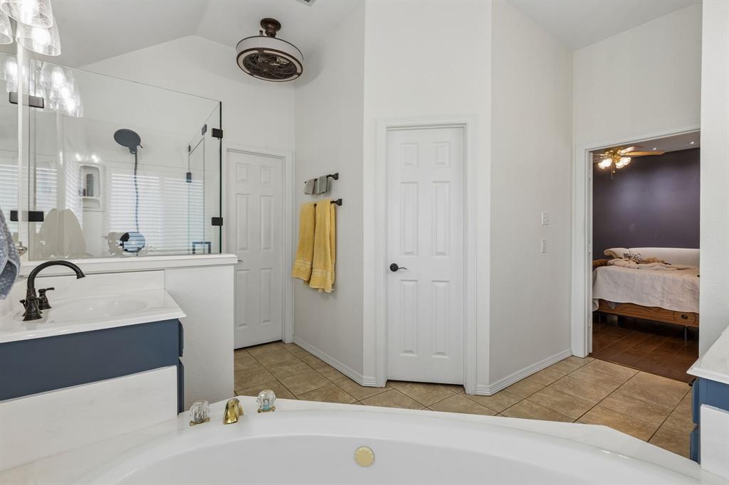 1901 Saw Tooth Court Haslet, TX 76052 - Photo 21 of 38 a bathroom with a sink a mirror and shower