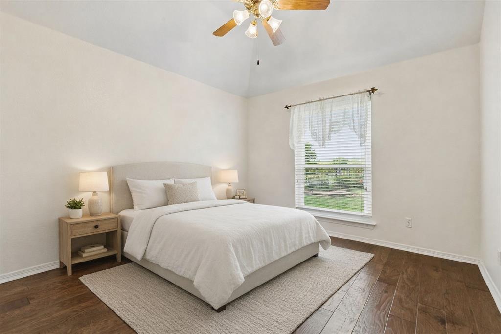 1901 Saw Tooth Court Haslet, TX 76052 - Photo 22 of 38 a bedroom with a large bed and a chandelier