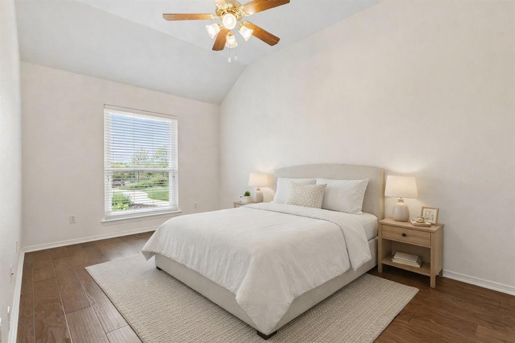 1901 Saw Tooth Court Haslet, TX 76052 - Photo 24 of 38 a bedroom with a large bed and a chandelier
