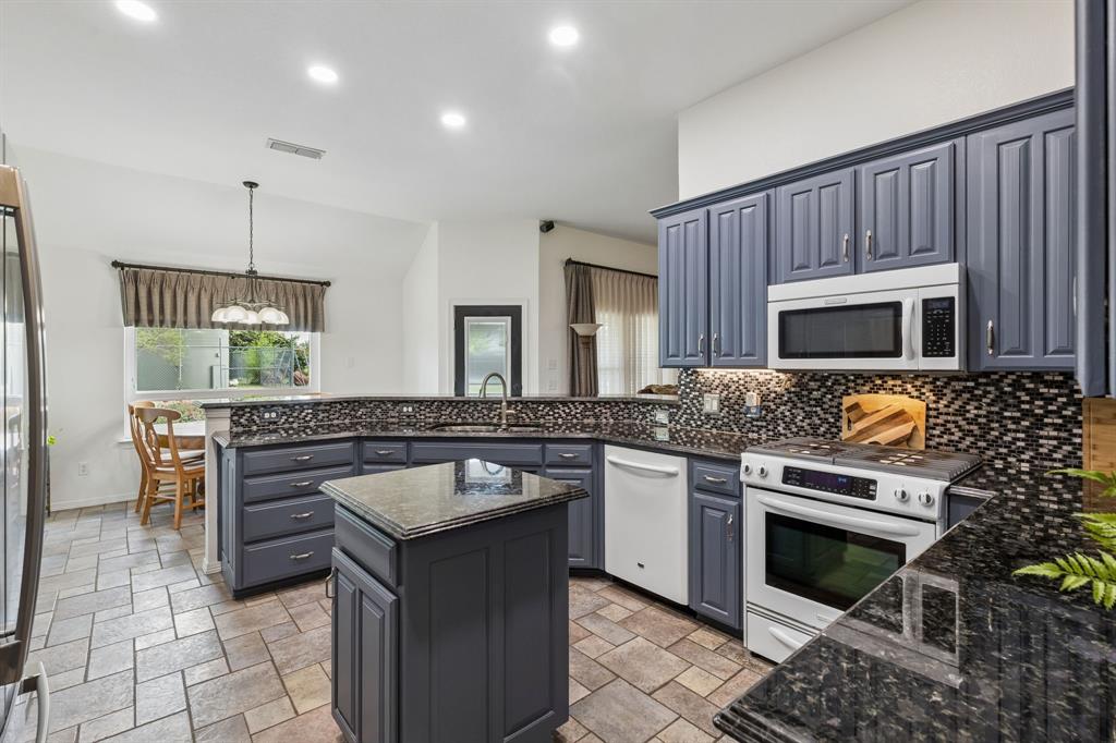 1901 Saw Tooth Court Haslet, TX 76052 - Photo 9 of 38 a kitchen with a stove and a microwave