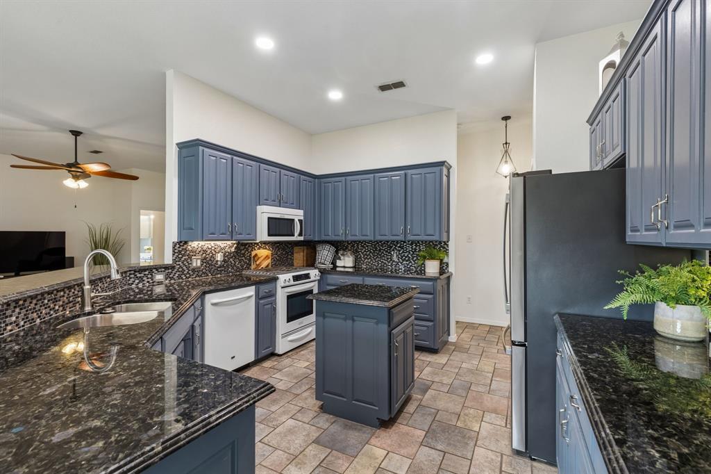 1901 Saw Tooth Court Haslet, TX 76052 - Photo 10 of 38 a kitchen with a sink a stove and a refrigerator