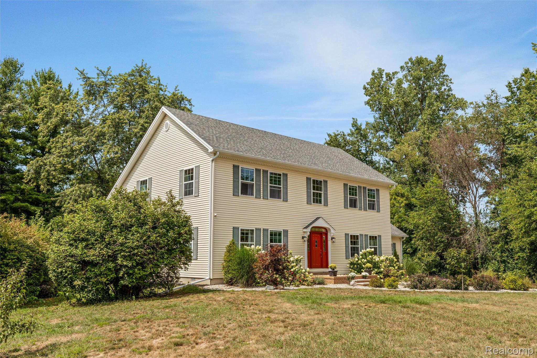 21280 Merriman Road New Boston, MI 48164 - Photo 2 of 65 Two-story residence with light-colored siding and a dark roof