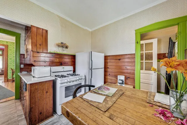 a bed room with a bed furniture and a flat tv screen