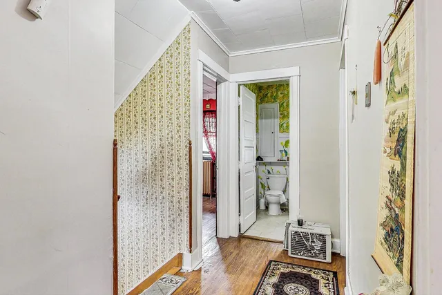 a view of an entryway with wooden floor