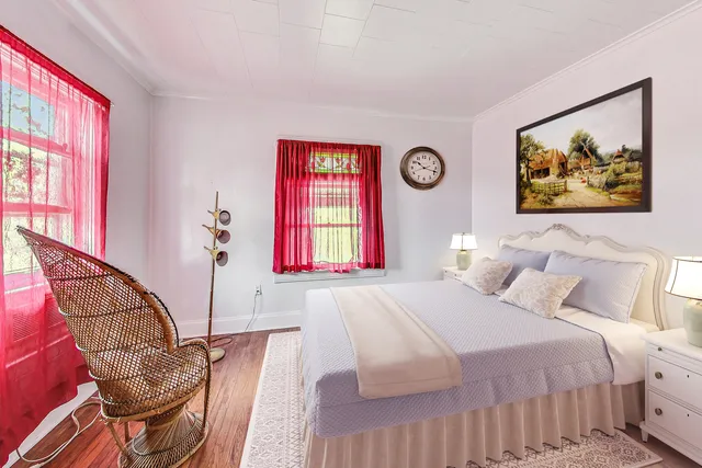 a bedroom with a bed and a painting on the wall