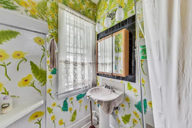 a bathroom with a sink a bathtub and a shower curtain