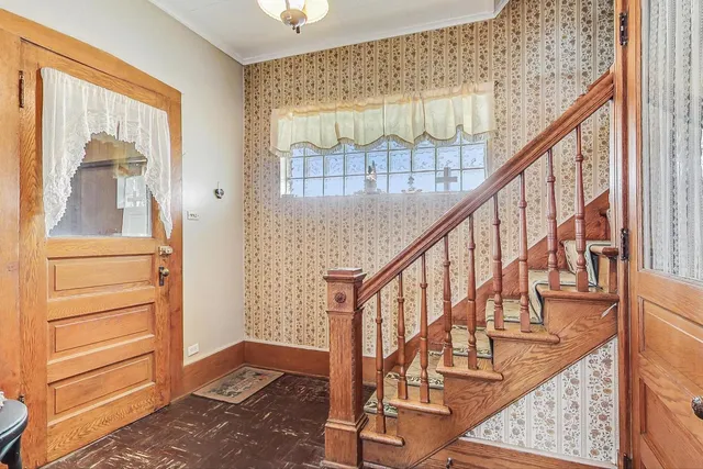 a view of an entryway with wooden floor