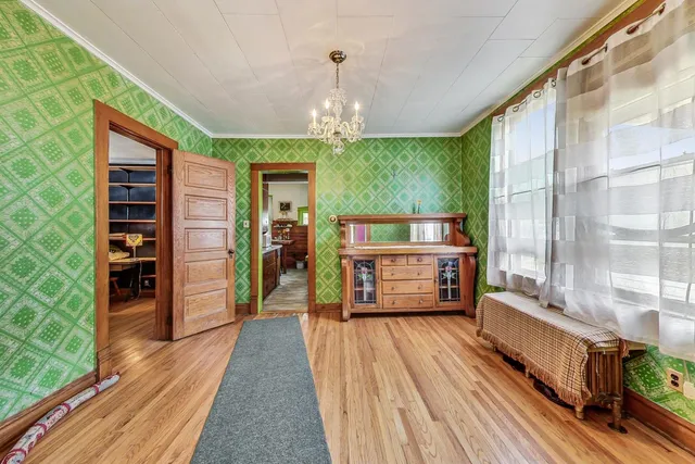 a view of a bedroom with furniture window and wooden floor