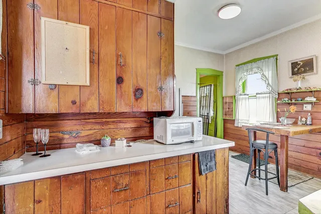 a kitchen with a sink cabinets and wooden floor