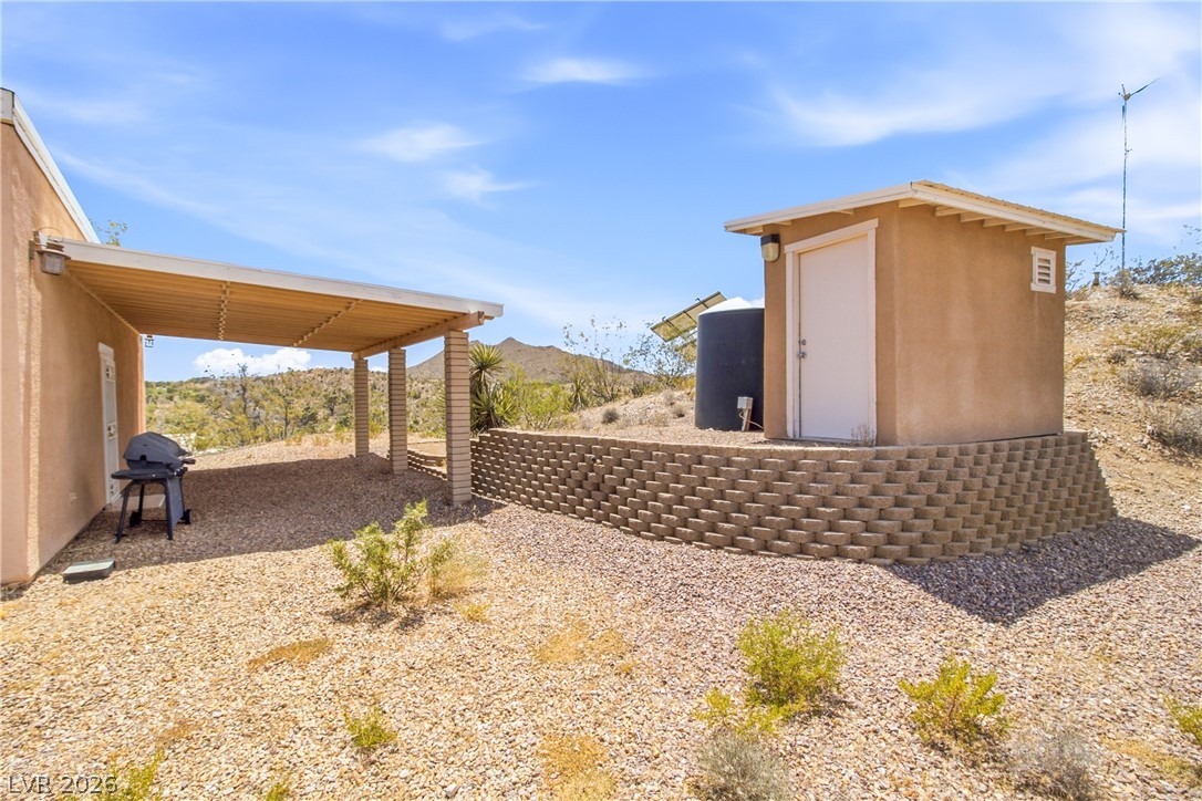 Rocking S Ranch Road Searchlight, NV 89046 - Photo 14 of 47 Enjoy outdoor living with a spacious covered patio, perfect for grilling and entertaining.