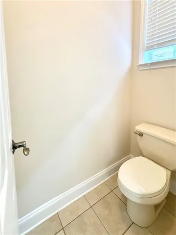 a white toilet sitting next to a shower