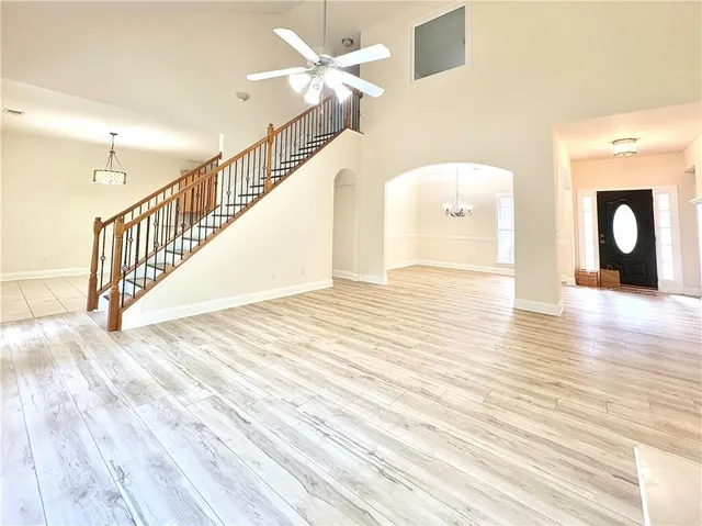 a view of a room with wooden floor and white walls