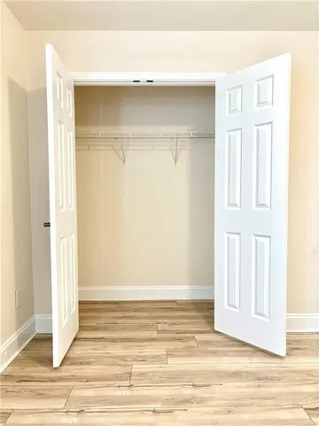 a view of room with wooden floor and entryway