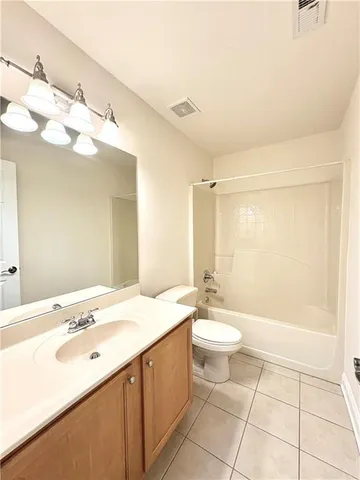 a bathroom with a double vanity sink mirror and toilet