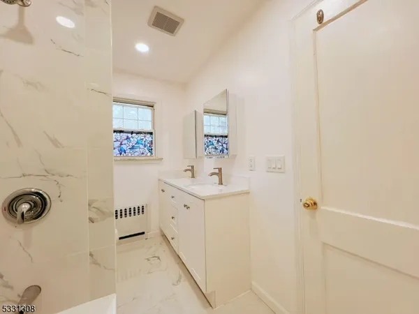 a bathroom with a sink a mirror and shower