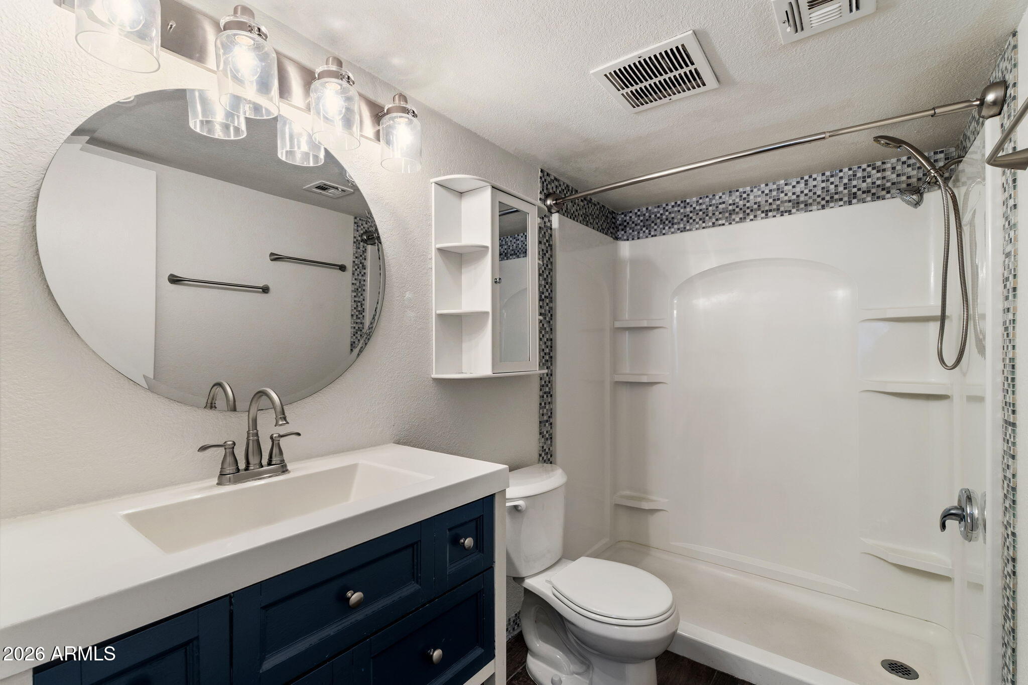 30 East Brown Road, Unit 2070 Mesa, AZ 85201 - Photo 11 of 20 a bathroom with a sink a toilet a mirror and shower