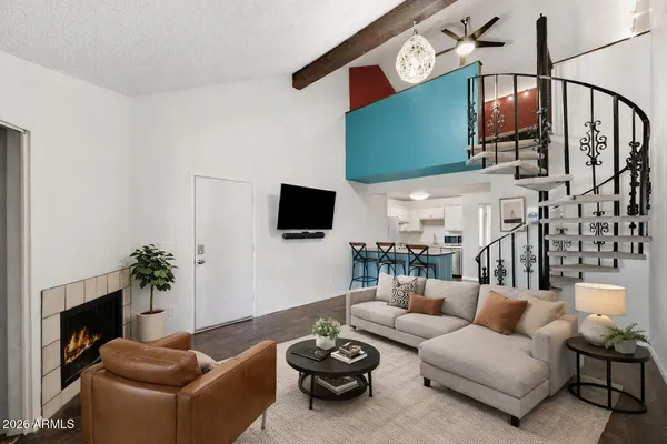 a living room with furniture a fireplace and a flat screen tv
