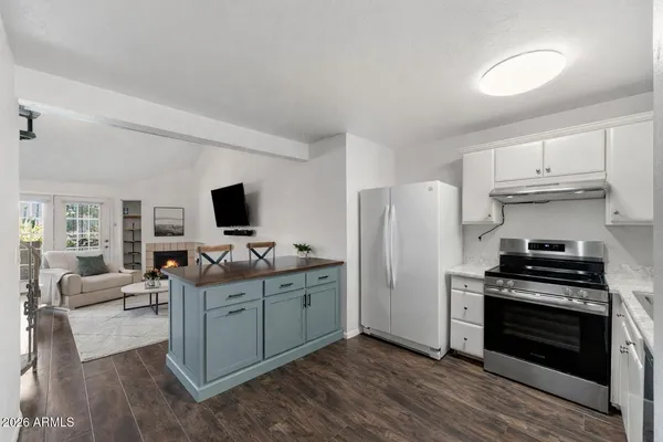 a kitchen with stainless steel appliances a stove refrigerator and microwave