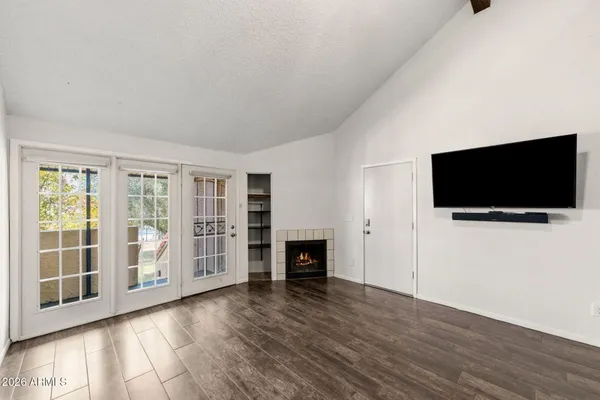 a view of a livingroom with wooden floor and a flat screen tv
