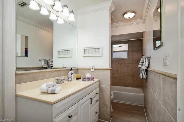 a dining room with furniture and a floor to ceiling window