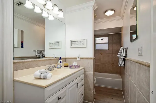 a dining room with furniture and a floor to ceiling window
